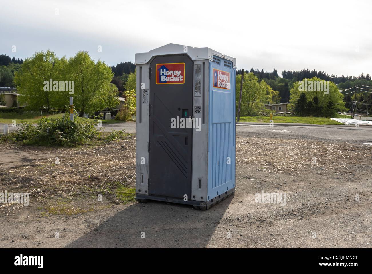 Woodinville, WA USA - circa May 2022: View of a Honey Bucket in the middle of a construction area downtown Stock Photo