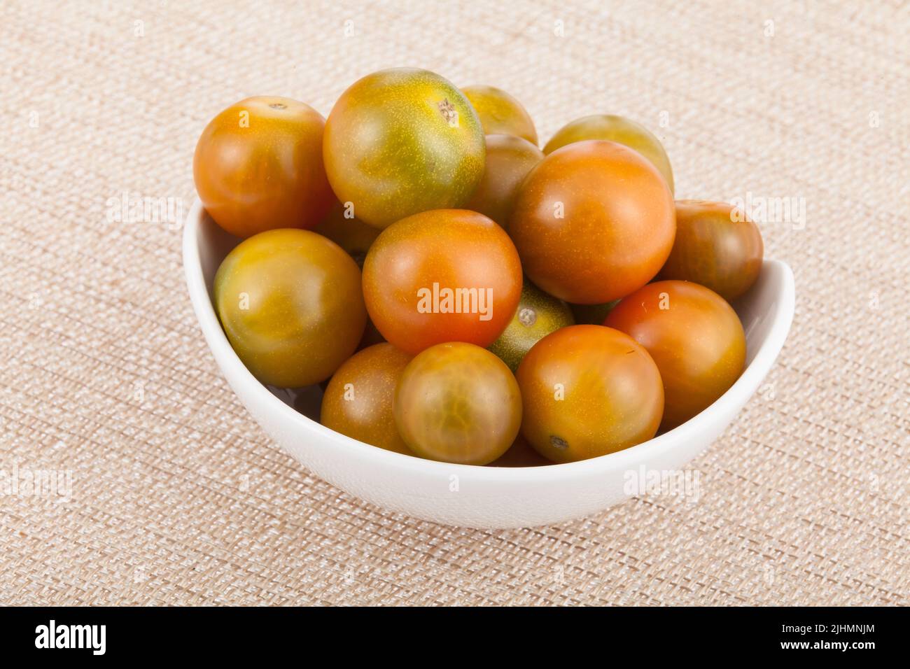 Bowl with cherry tomatoes - Solanum pimpinellifolium. Stock Photo