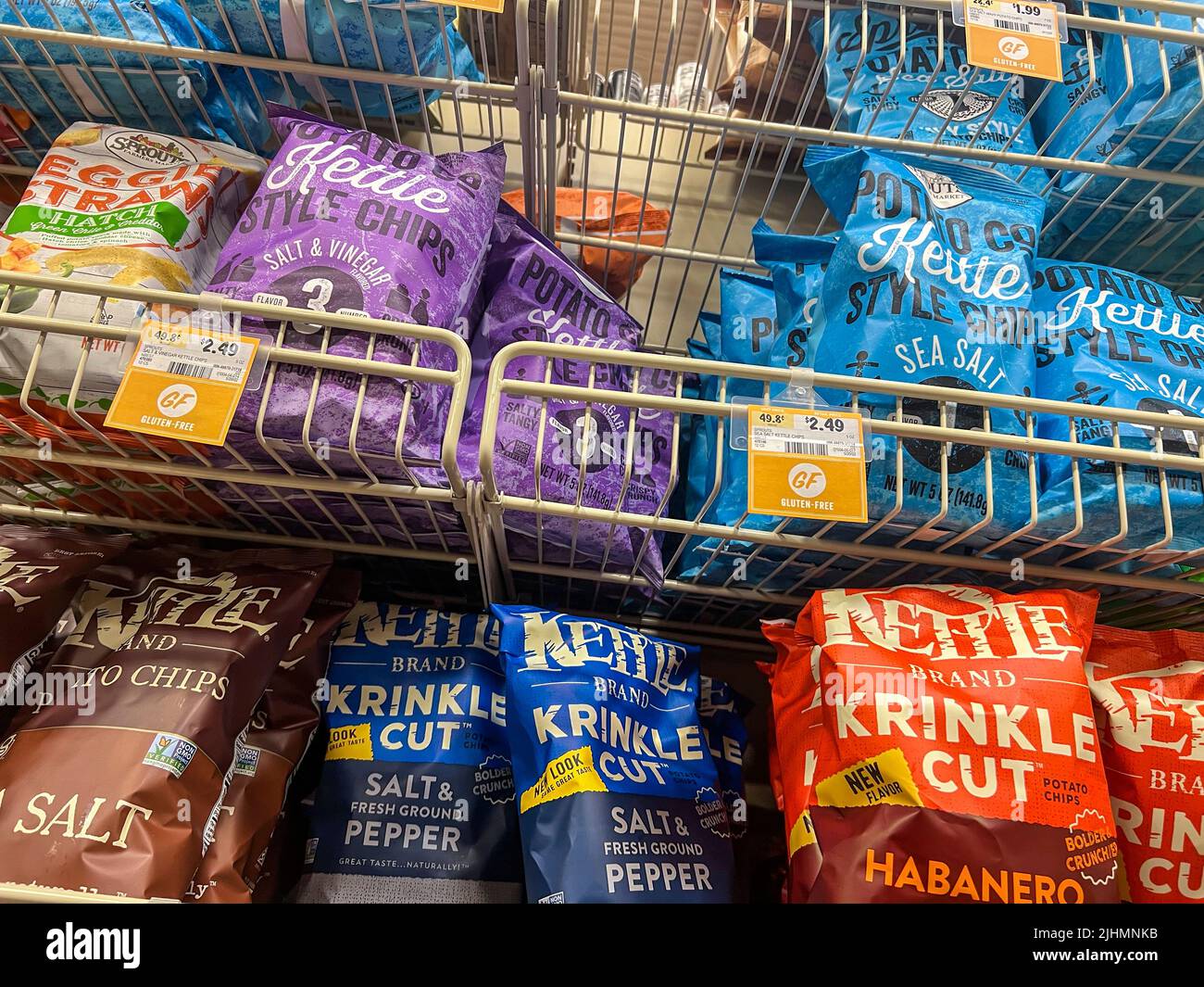 Mill Creek, WA USA - circa June 2022: Low angle view of a variety of kettle cooked chips for sale inside a Sprouts Market. Stock Photo
