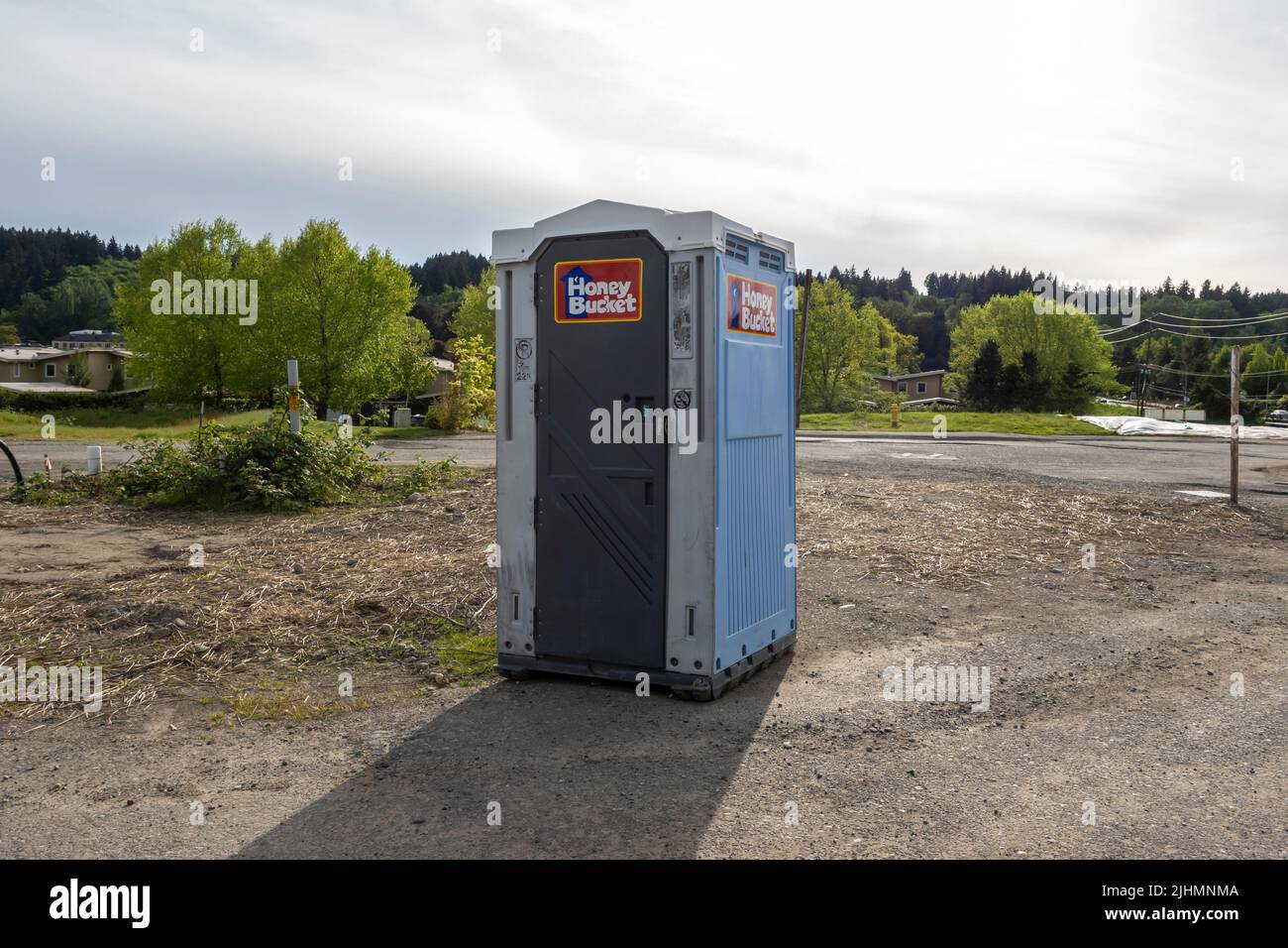 Woodinville, WA USA - circa May 2022: View of a Honey Bucket in the middle of a construction area downtown. Stock Photo