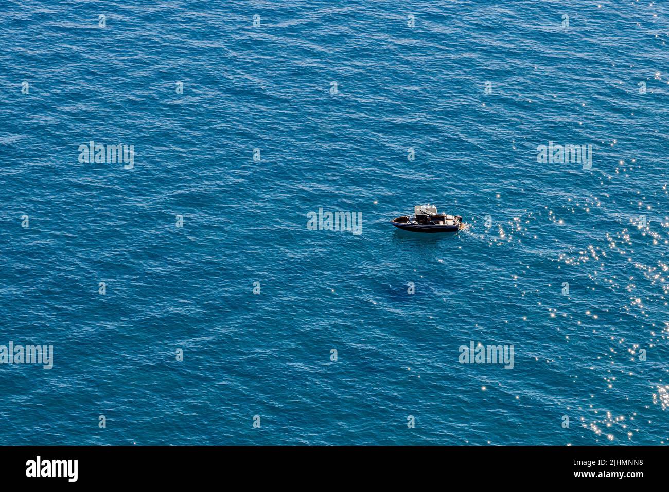 A boater on Lake Tahoe heading toward Zephyr Cove as seen from cave rock Stock Photo