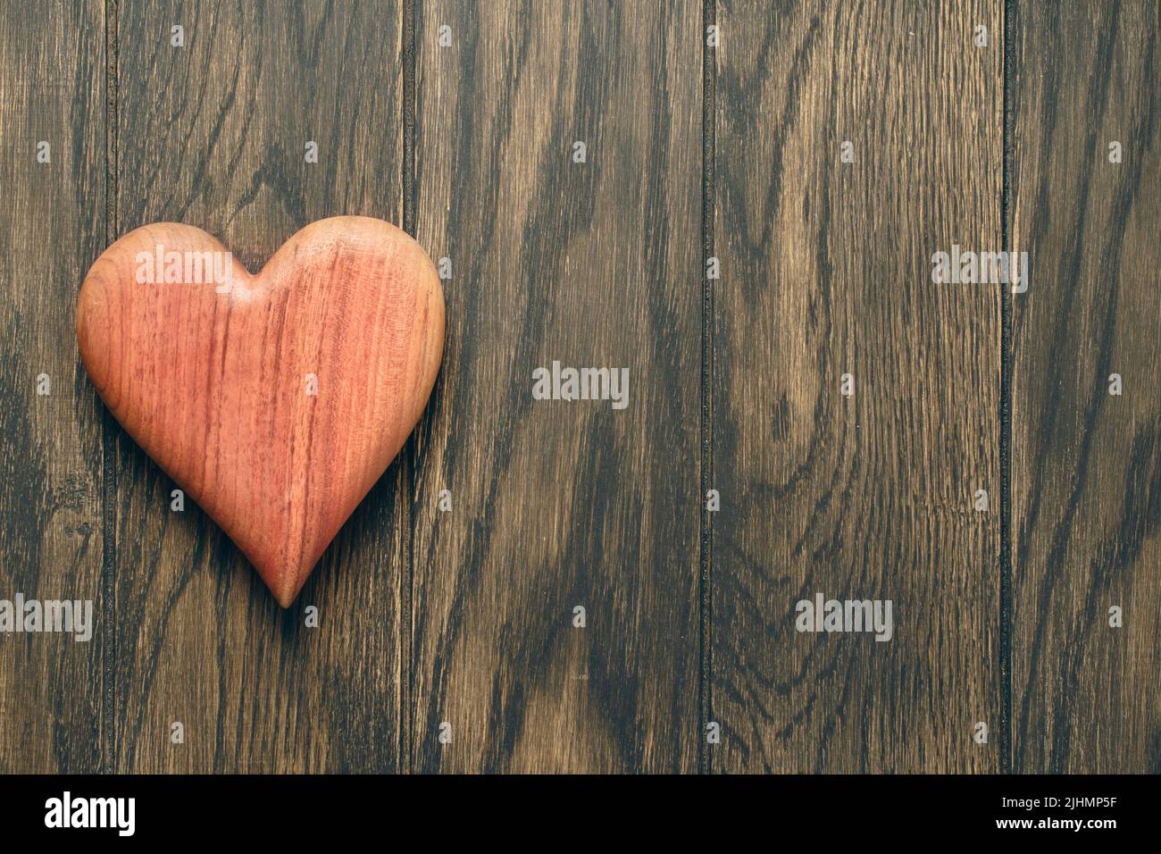 Wooden heart on oak table with copy space Stock Photo