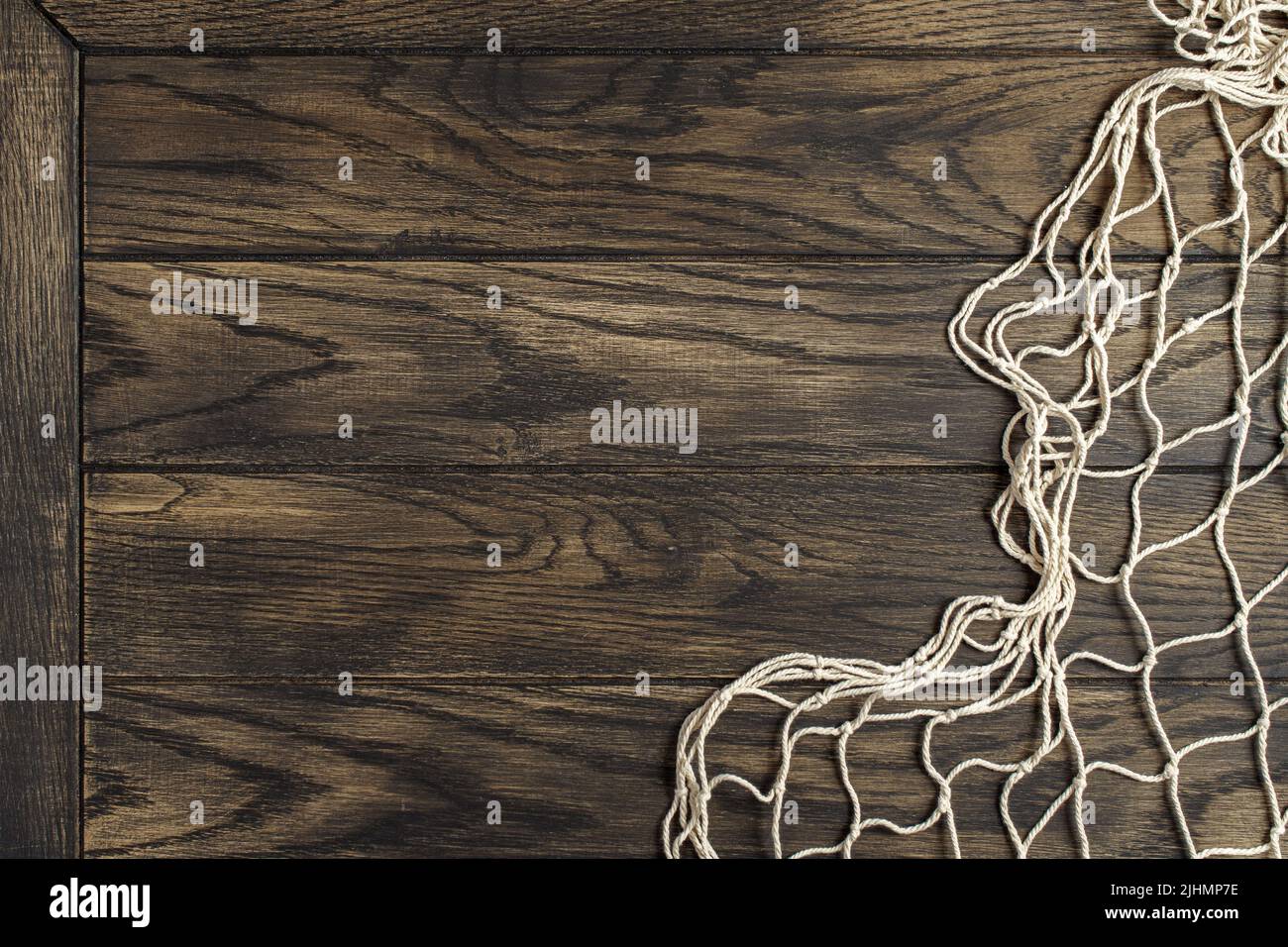 Fishing net on old oak board background with copy space Stock Photo