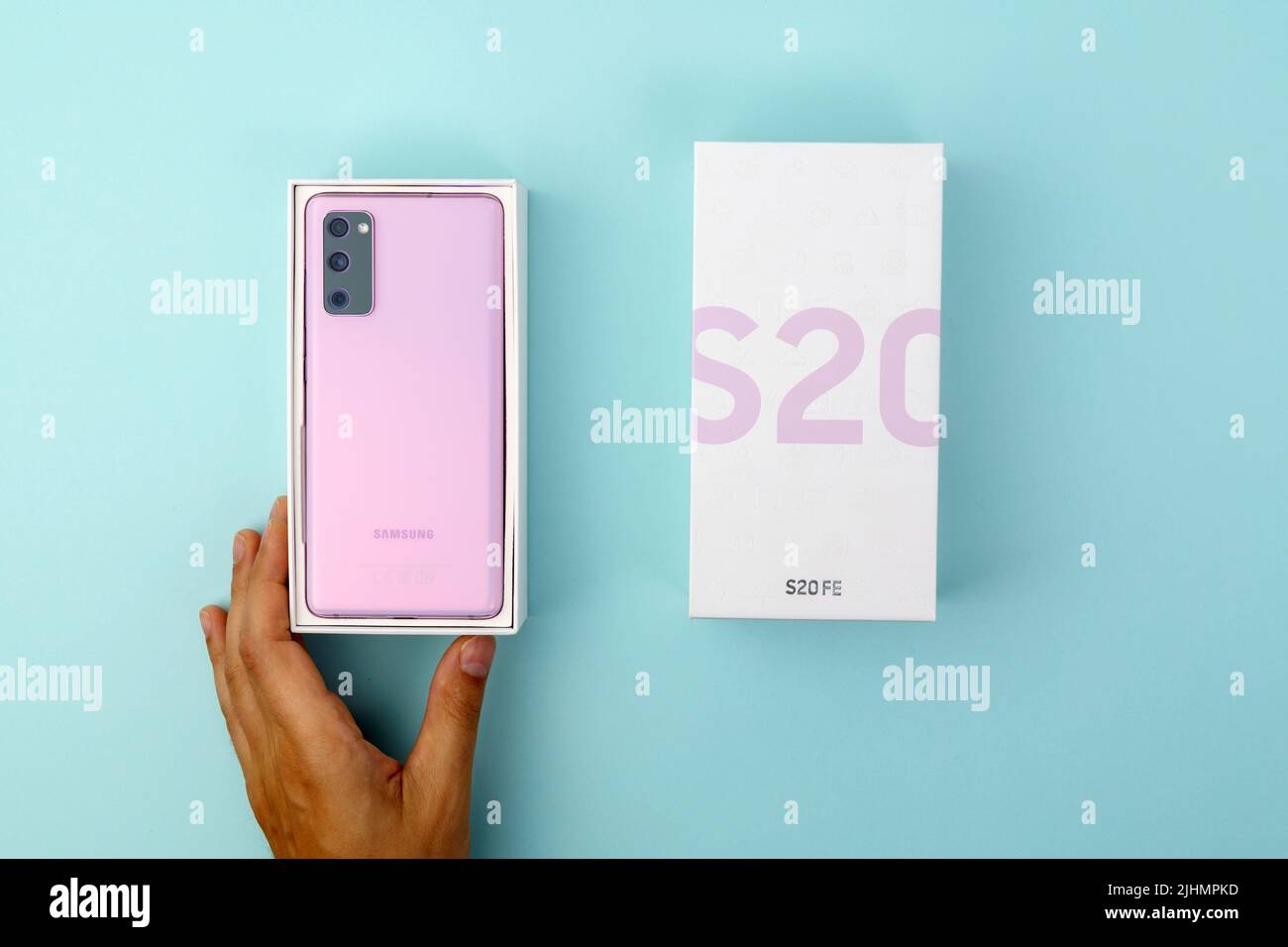 Tyumen, Russia-July 18, 2022: New Samsung s20 fe smartphone in a box. Top view, blue background Stock Photo
