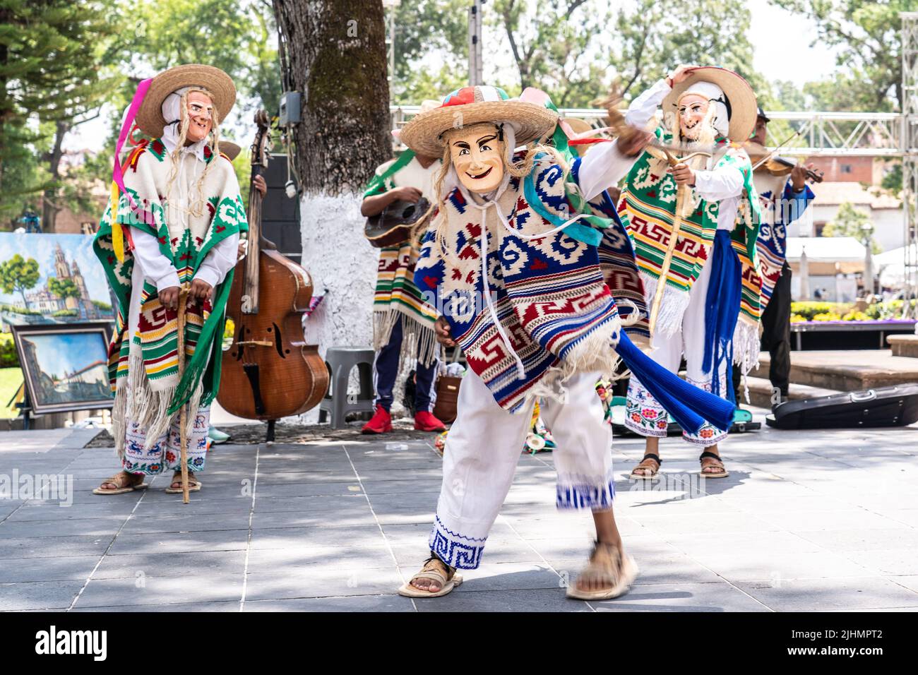 Young Mexican boys, dressed in the traditional old man costume, perform the traditional Danza de los Viejitos at the Plaza Vasco de Quiroga town square, April 11, 2022 in Patzcuaro, Michoacan, Mexico. Stock Photo