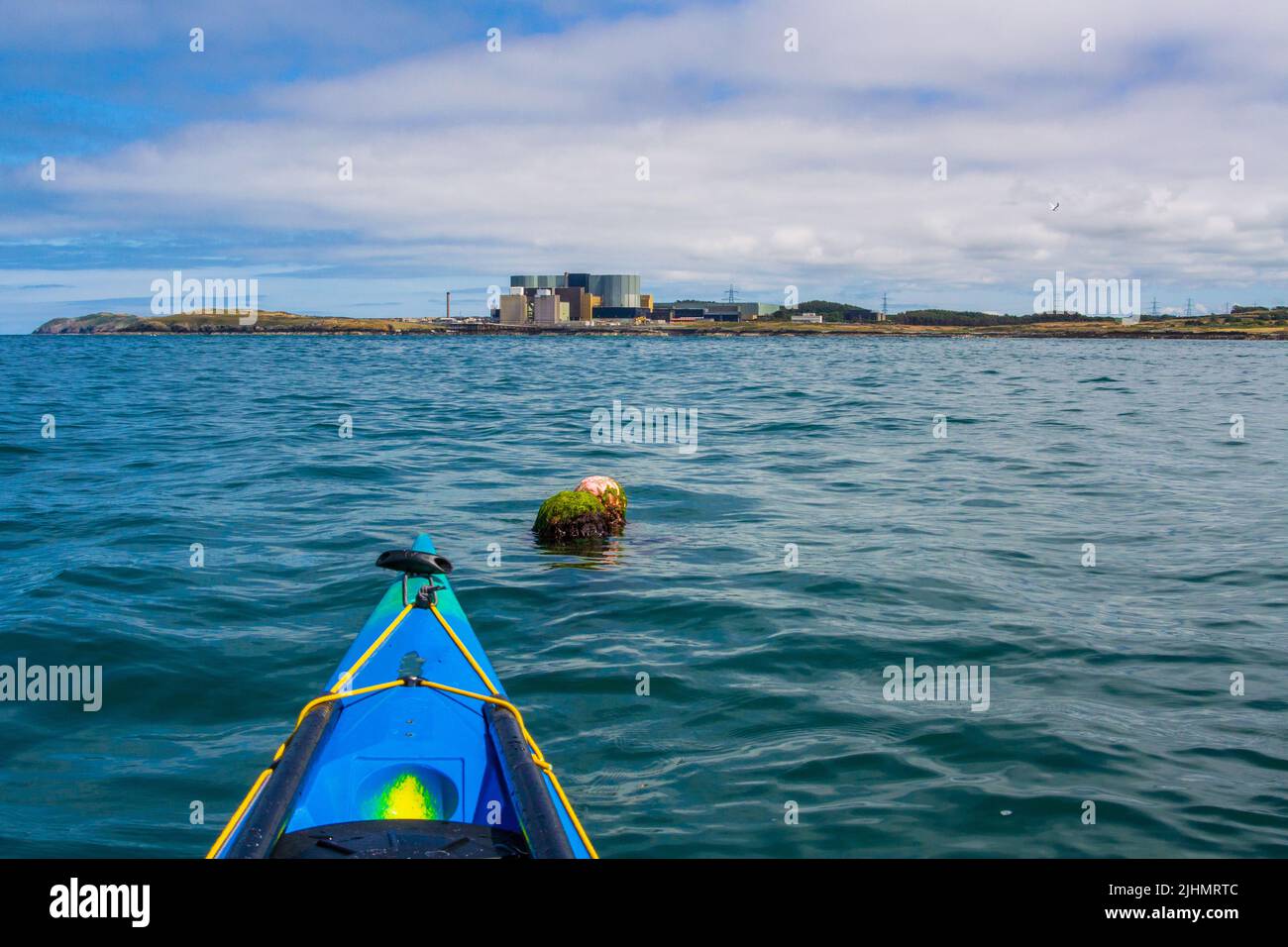 Sea kayaking / canoeing on the coast of Anglesey, North Wales, UK Stock Photo