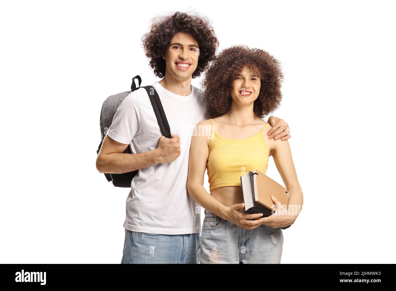 Male and female students with curly hair with books and backpack smiling at camera isolated on white background Stock Photo