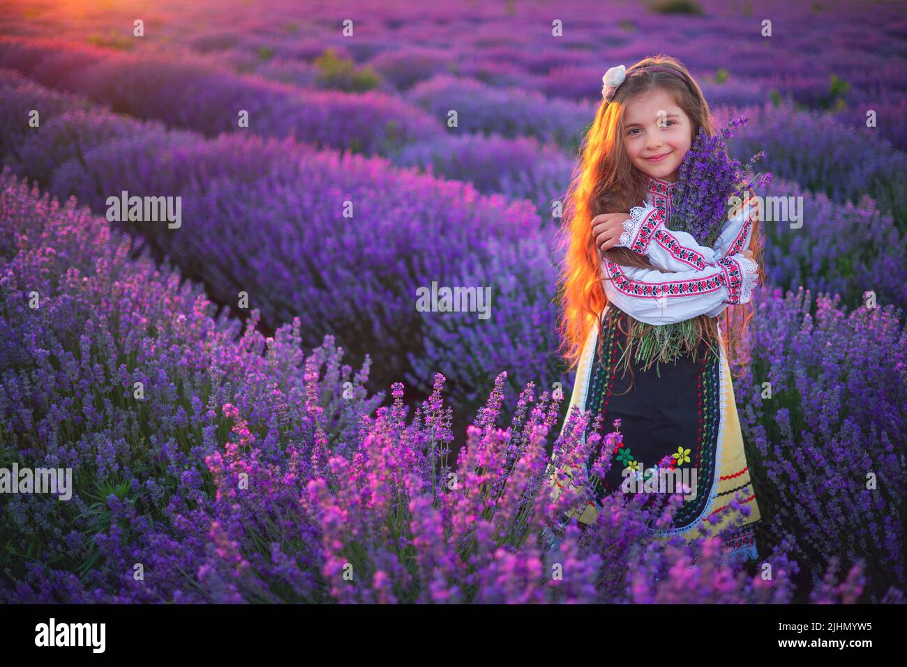 Girl with traditional folklotr bulgarian dress in field field Stock Photo