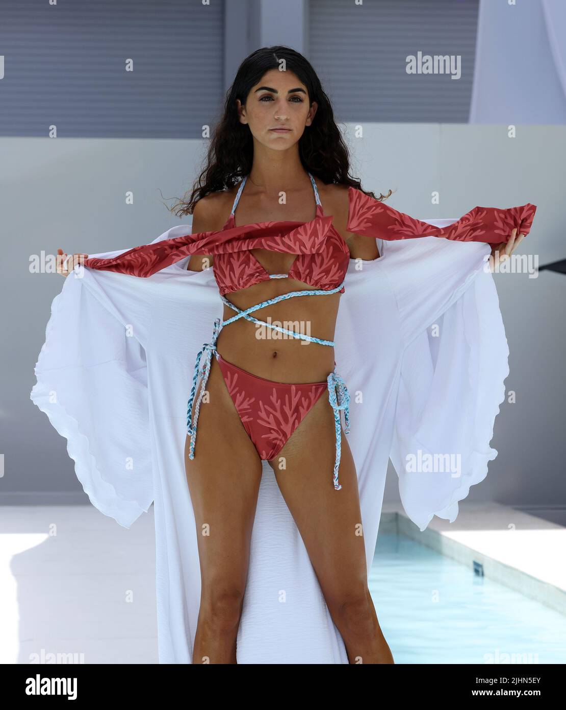 MIAMI BEACH, FLORIDA - JULY 18: A model walks the runway wearing