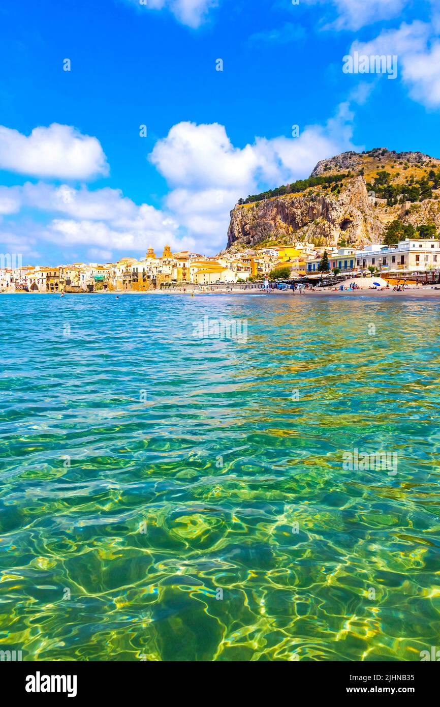 Crystal clear azure water of Mediterranean sea at Cefalu beach in Cefalu town, Sicily, Italy. One of the best beach on Sicily island Stock Photo