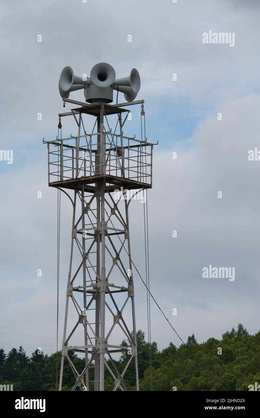 Four loud speakers on top of a metal tower Stock Photo