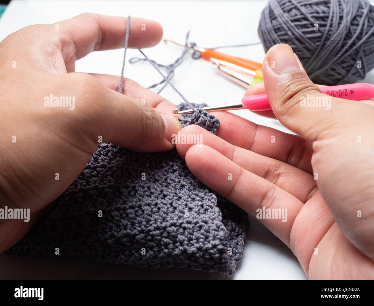 Close up shoot of knitting with crochet technique equipment Stock Photo ...