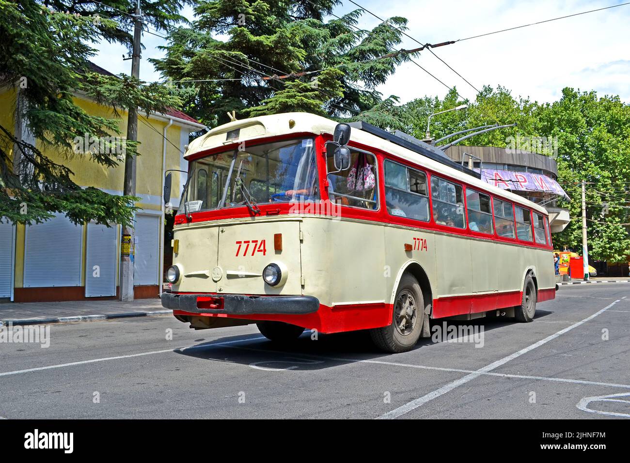 Crimean vintage trolleybus  (trackless trolley)  Shkoda 9Tr on the road  in Alushta, Crimea, Ukraine. Stock Photo