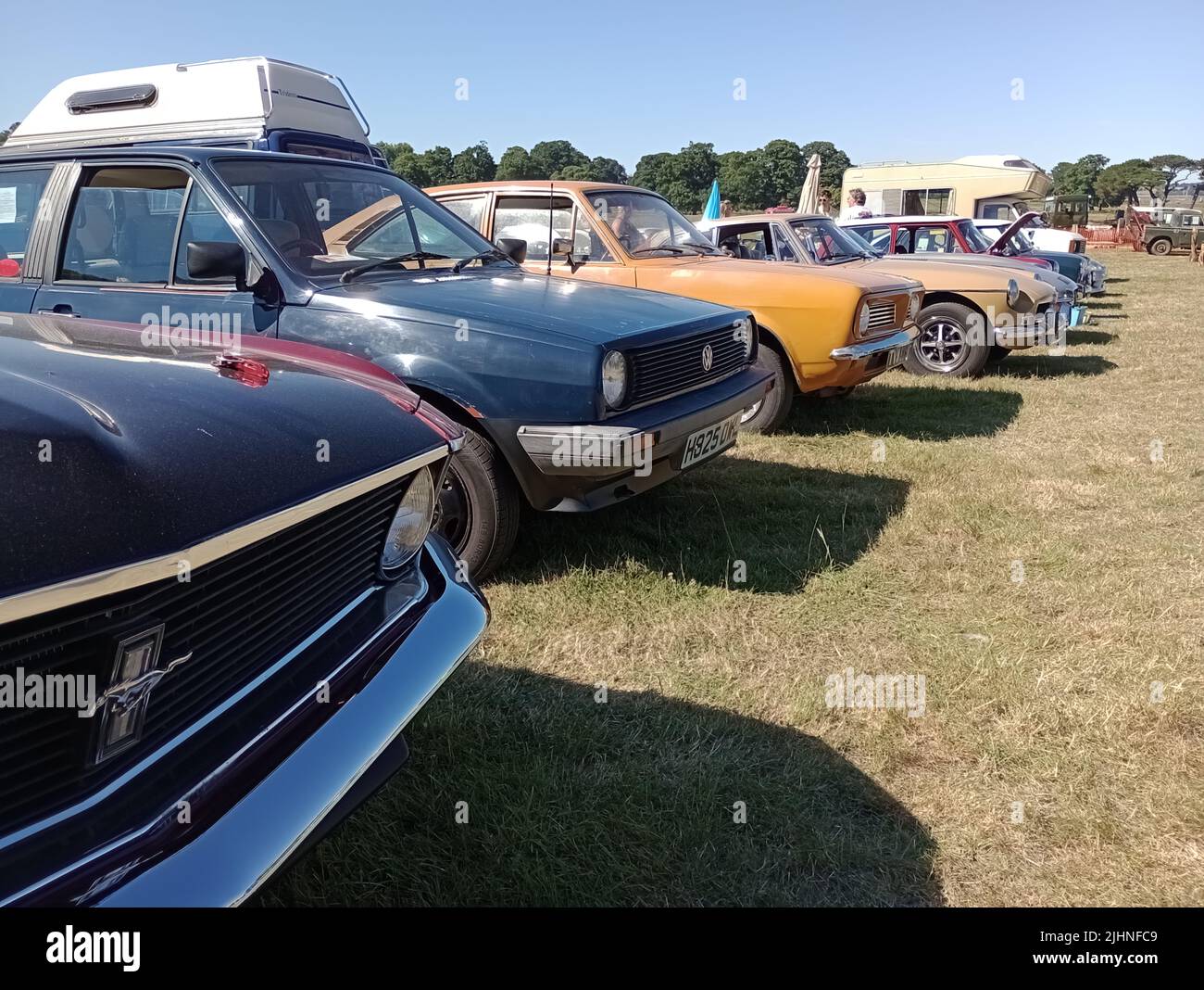 A line of classic cars parked on display at the 47th Historic Vehicle