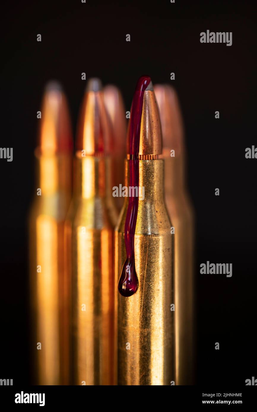 AR-15 style rifle cartridge and blood (photoillustration). Stock Photo