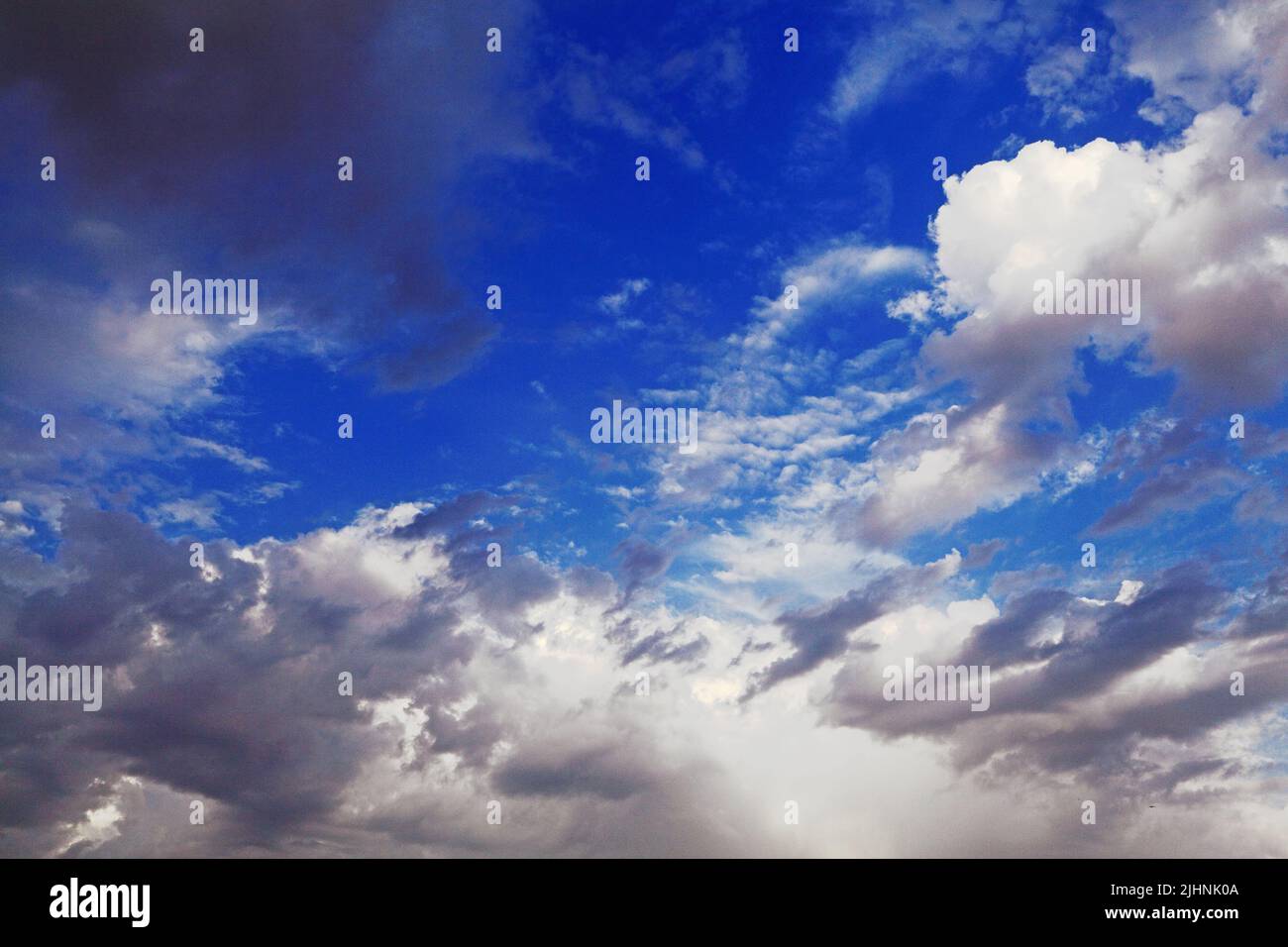 White, grey, dark clouds, formation, blue sky Stock Photo