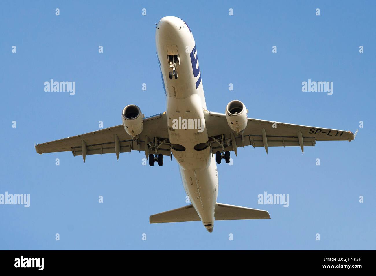SAINT PETERSBURG, RUSSIA - JUNE 20, 2018: Aircraft Embraer ERJ-175 (SP-LII) of LOT - Polish Airlines flies overhead in a blue cloudless sky Stock Photo