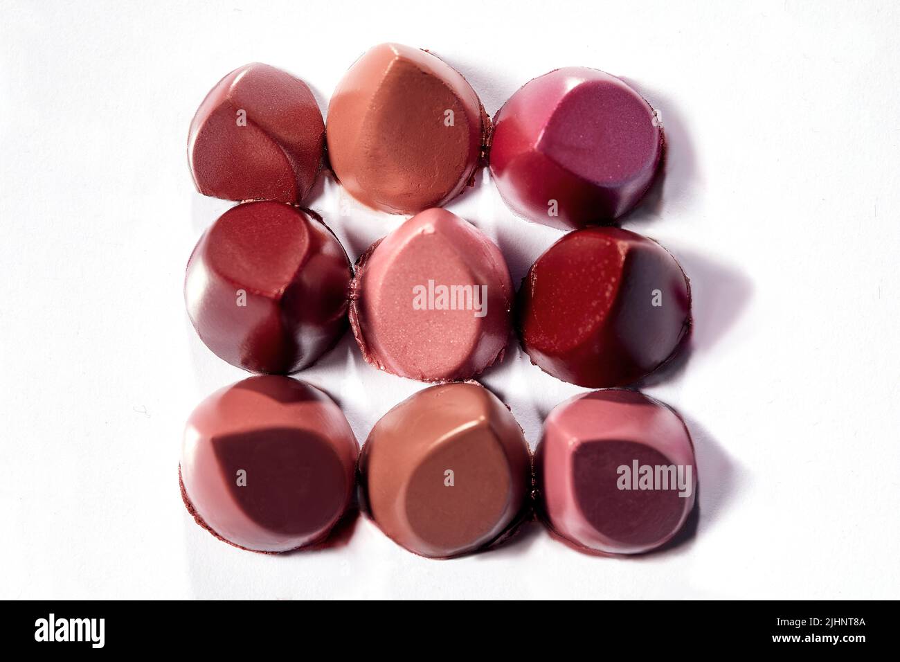 Lipctick bullet macro. Nine lipstick bullets slised and arranged on