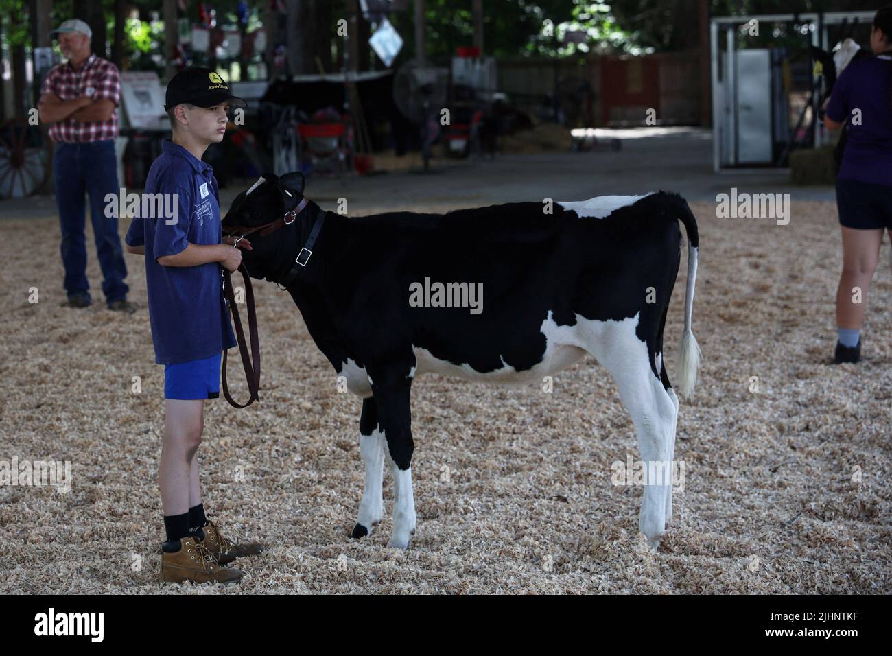 A boy stands with a cow during practice for a livestock competition at the 2022 Saratoga County Fair in Ballston Spa, New York, U.S., July 19, 2022. REUTERS/Shannon Stapleton Stock Photo