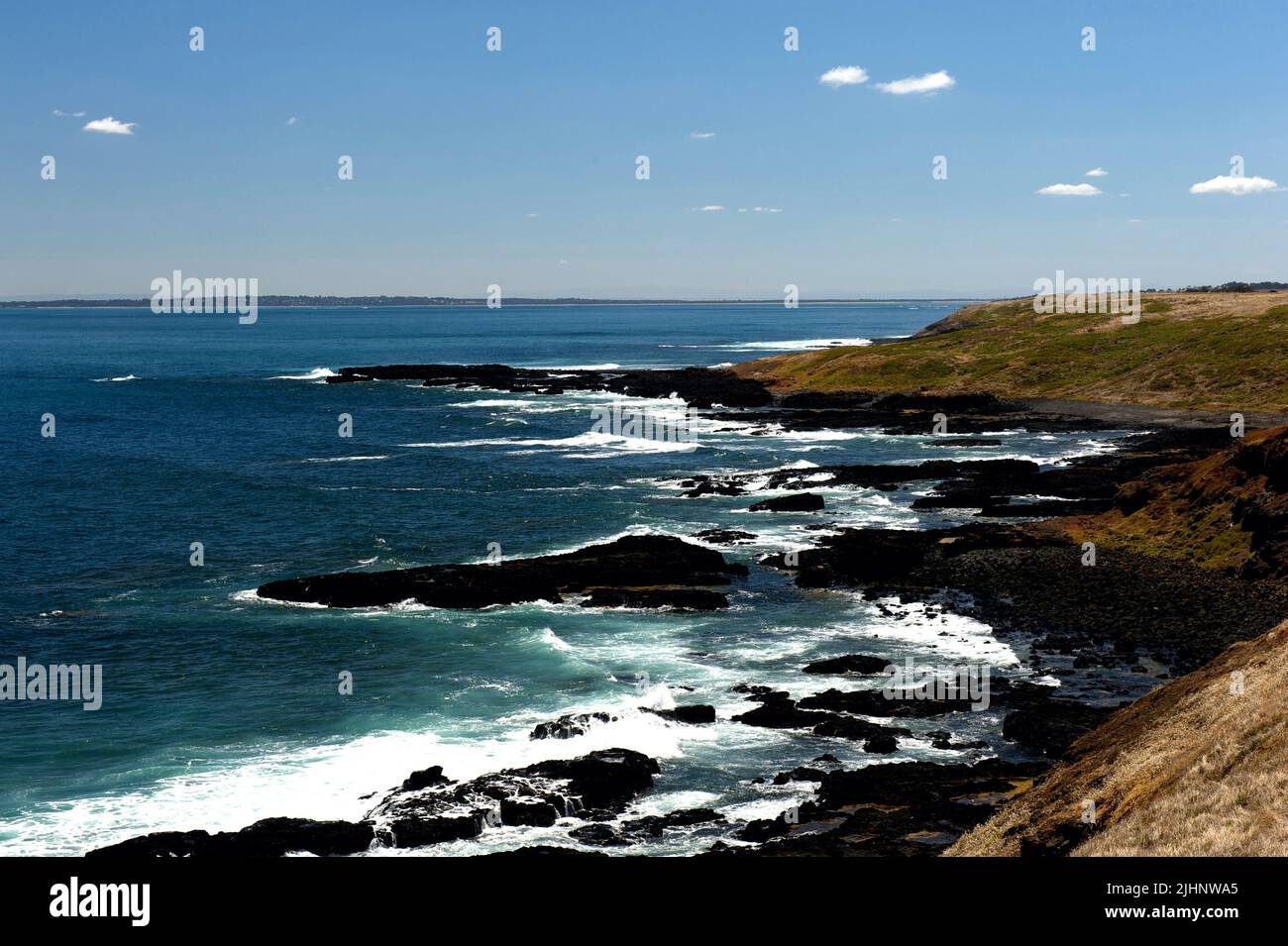The rocky coast of Phillip Island in Victoria, Australia, looking out across Westernport Bay.The island does have some popular, sandy beaches. Stock Photo