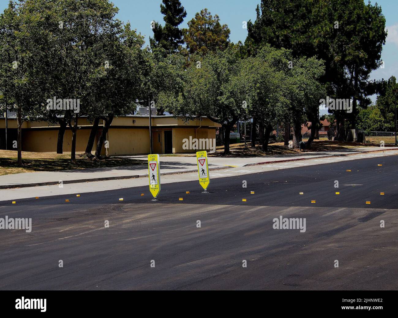 State Law, yield to pedestrians within crosswalk marker, in front of