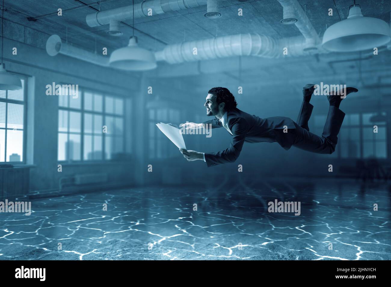 Business man with paper and pen underwater Stock Photo Alamy