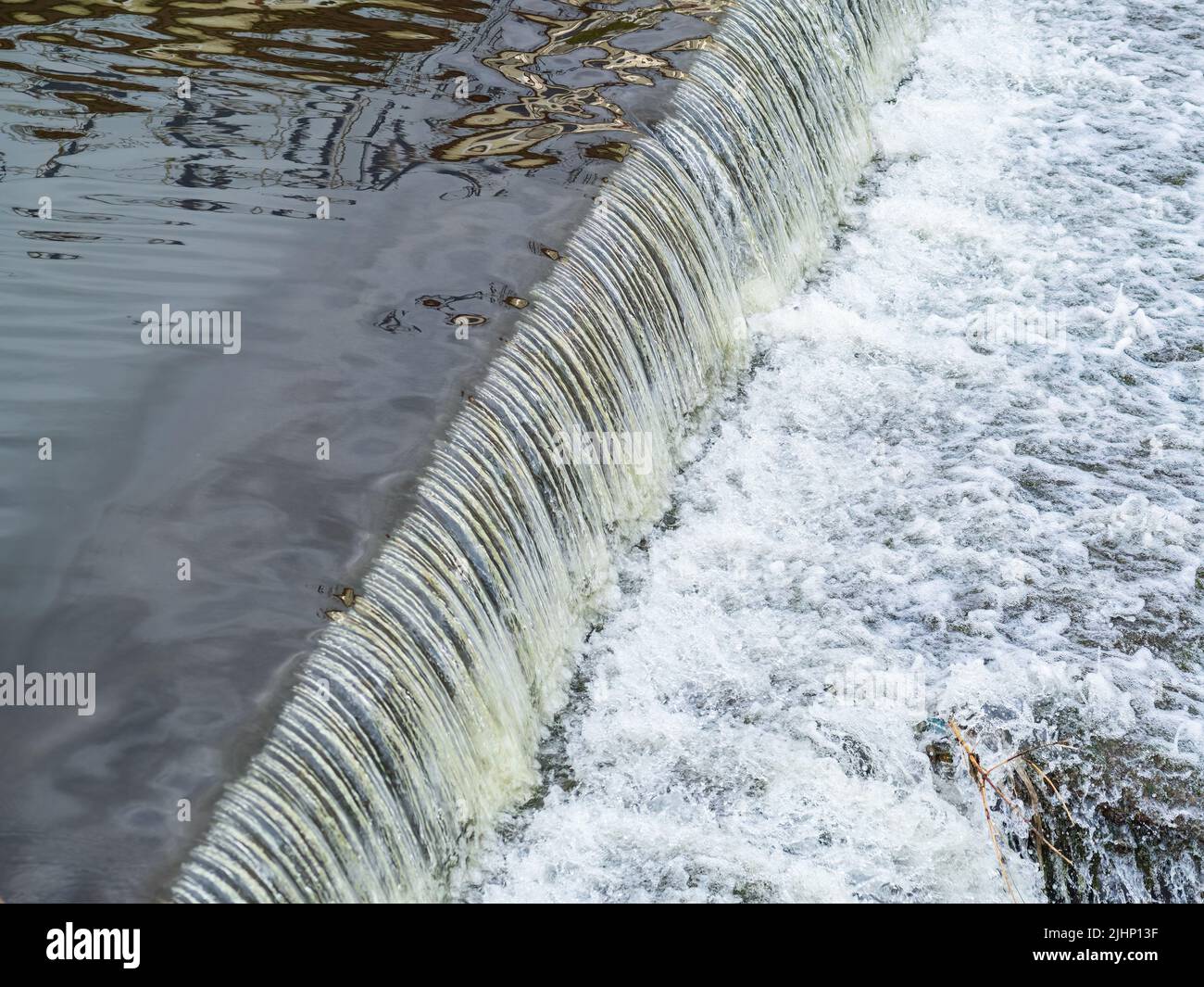 A small flat cascade in a calm river. Water background Stock Photo - Alamy