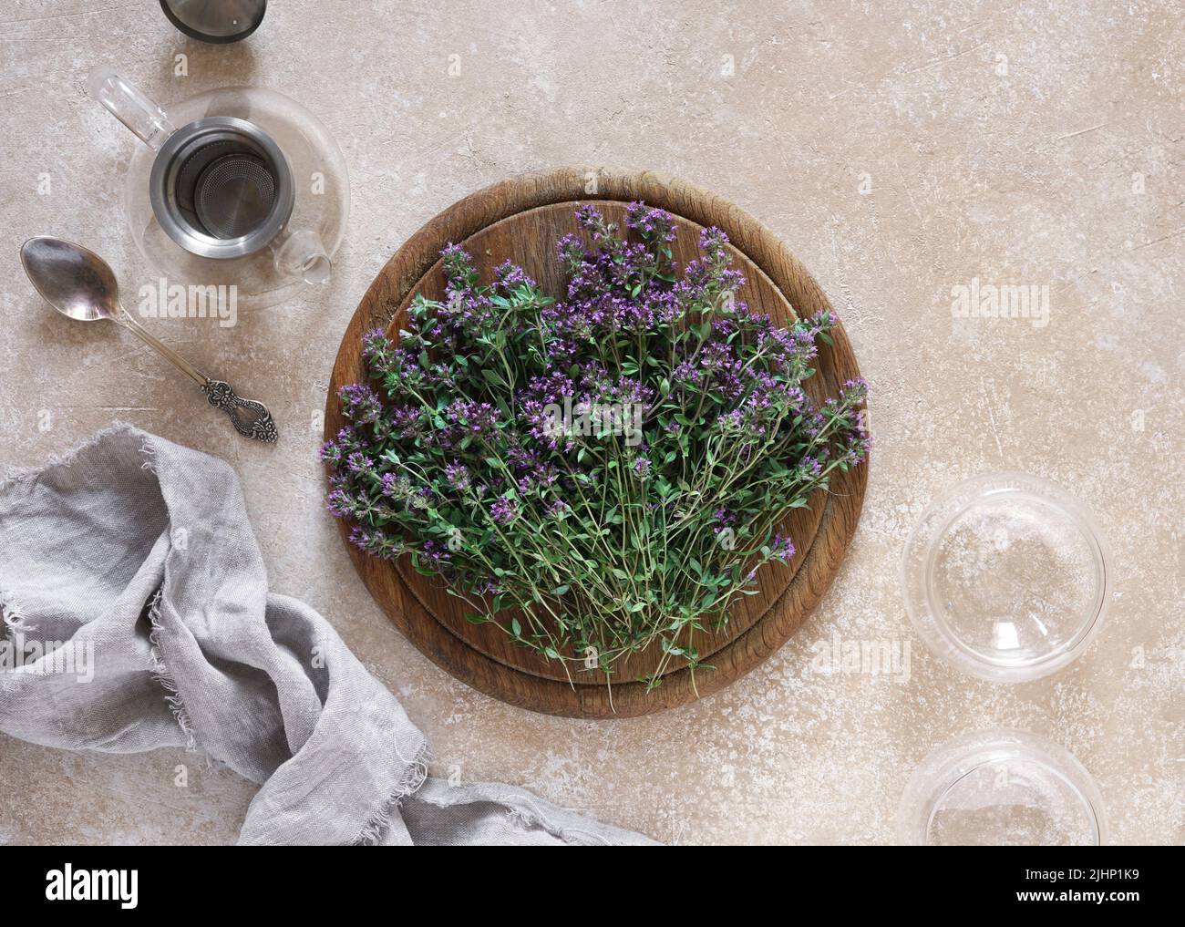 Thymus serpyllum, Thyme on wooden desk with empty teapot and cups, top view, copy space Stock Photo