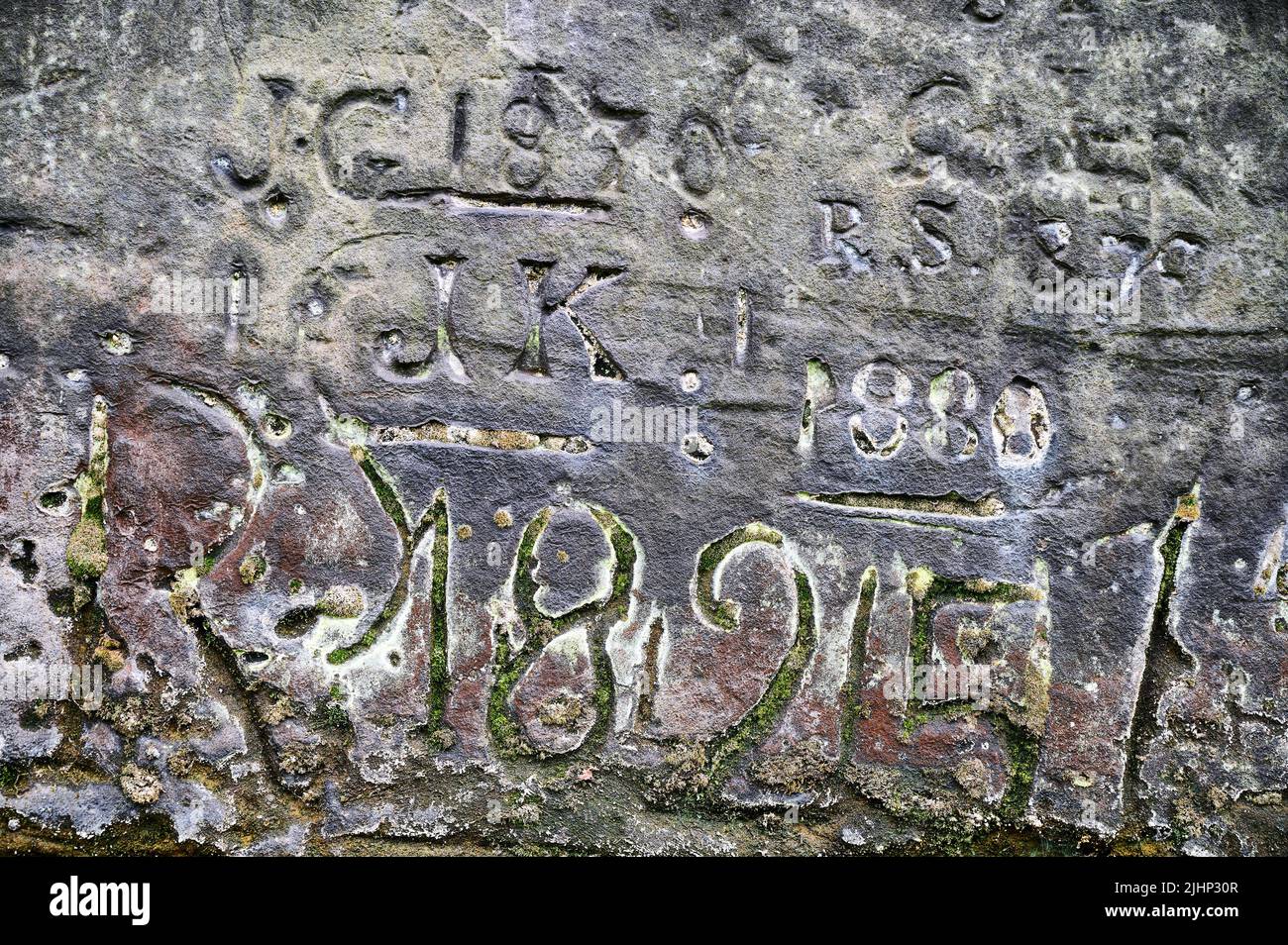 Dates and names carved into rockface of St Jame's gardens,Liverpool Stock Photo