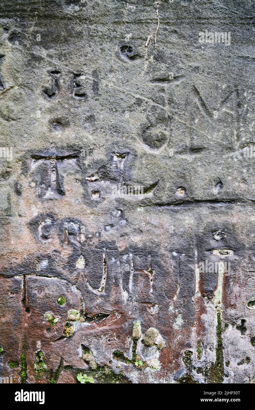 Dates and names carved into rockface of St Jame's gardens,Liverpool Stock Photo