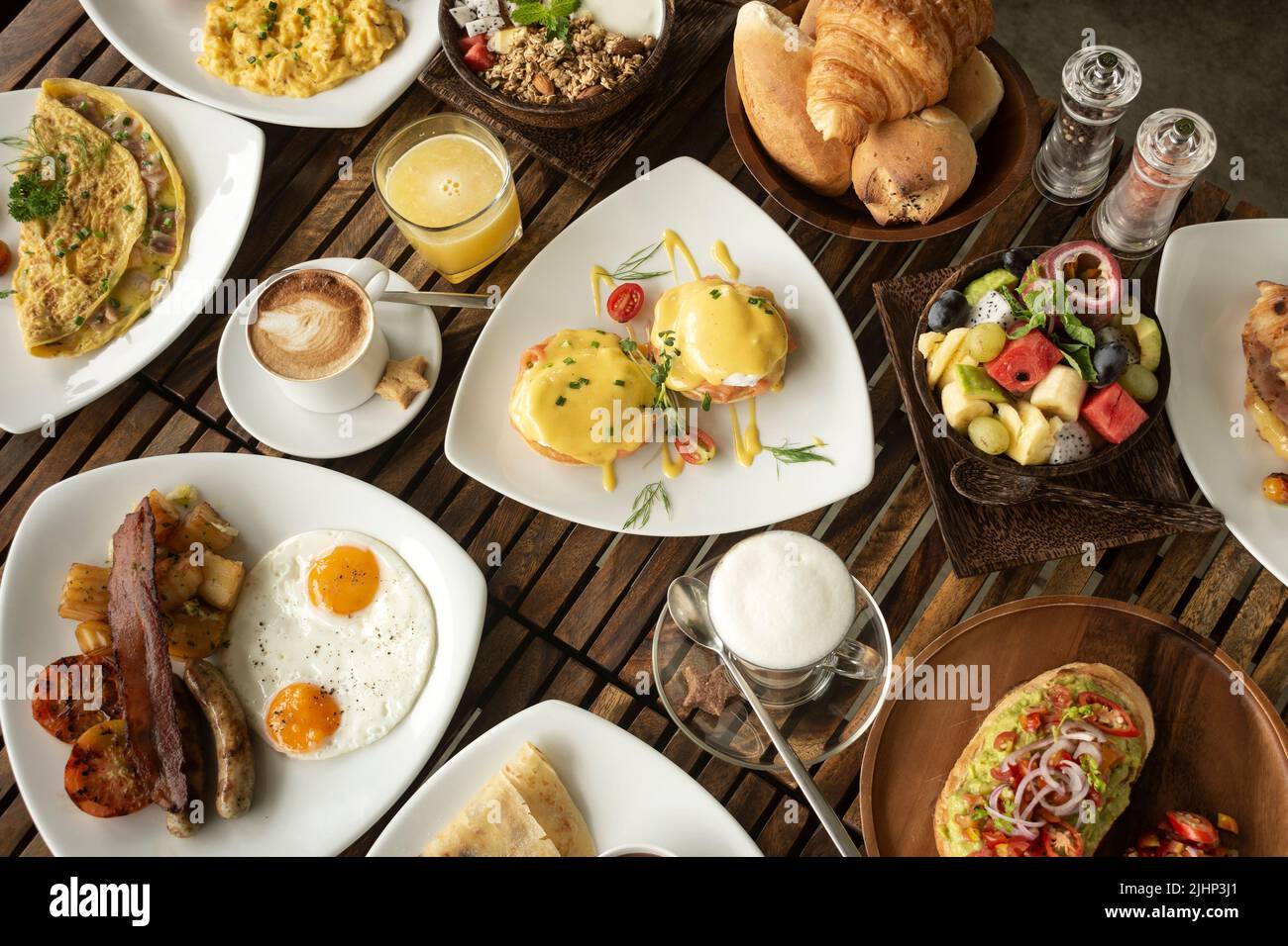 many mixed western breakfast food items on cafe table Stock Photo