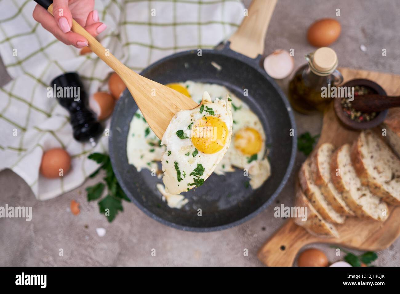 Fried Egg in cast iron frying pan on black induction hob Stock Photo