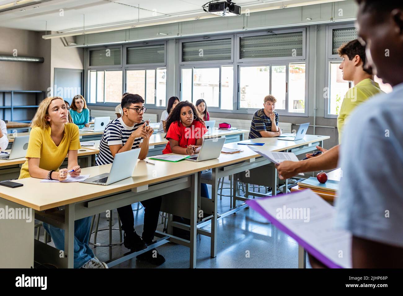 Young group of diverse high school students giving a presentation in classroom Stock Photo