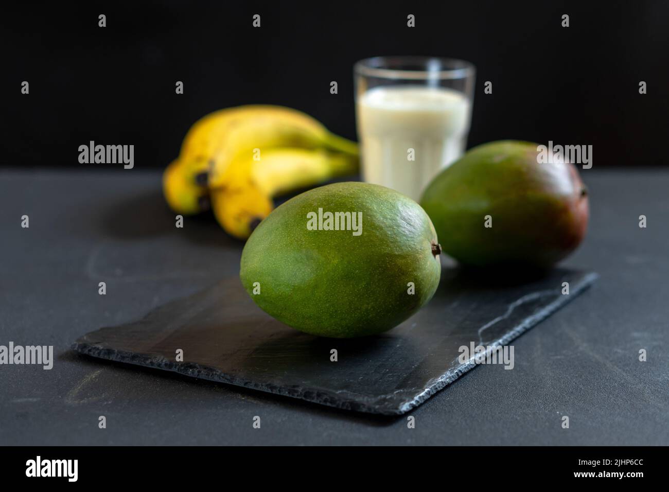 Ingredients for making mango fruit yogurt. Lassi drink preparation. Stock Photo