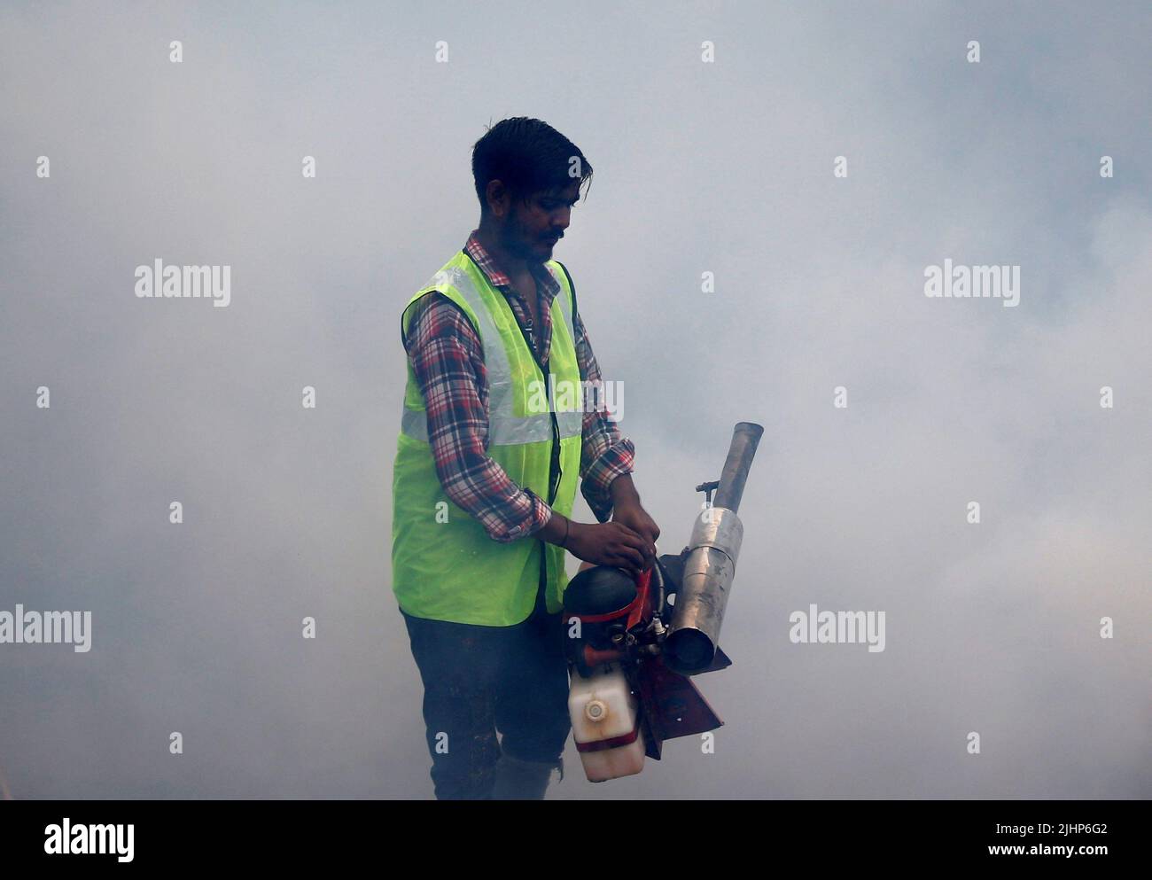 A health worker fumigates a residential neighbourhood during a drive to prevent the spread of mosquito-borne diseases following recent rainfall and water logging, in Ahmedabad, India, July 20, 2022. REUTERS/Amit Dave Stock Photo