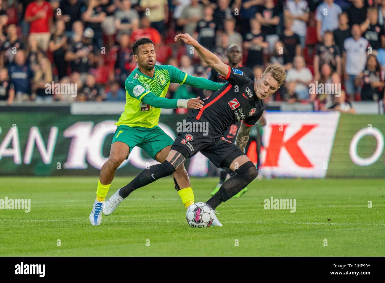 Herning, Denmark. 19th July, 2022. Charles (35) of FC Midtjylland and Gus Ledes (7) of AEK Larnaca seen during the UEFA Champions League qualification match between FC Midtjylland and AEK Larnaca at MCH Arena in Herning. (Photo Credit: Gonzales Photo/Alamy Live News Stock Photo
