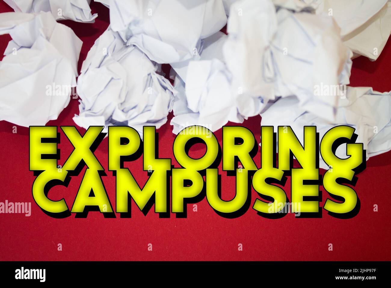 Exploring Campuses text with Torn, Crumpled White Paper on colored background. Stock Photo