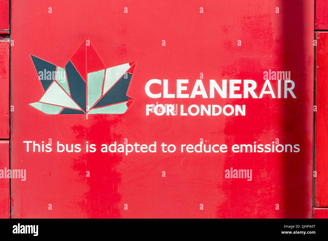 Red bus with Cleaner air for London slogan on side, this bus is adapted to reduce emissions. Stock Photo
