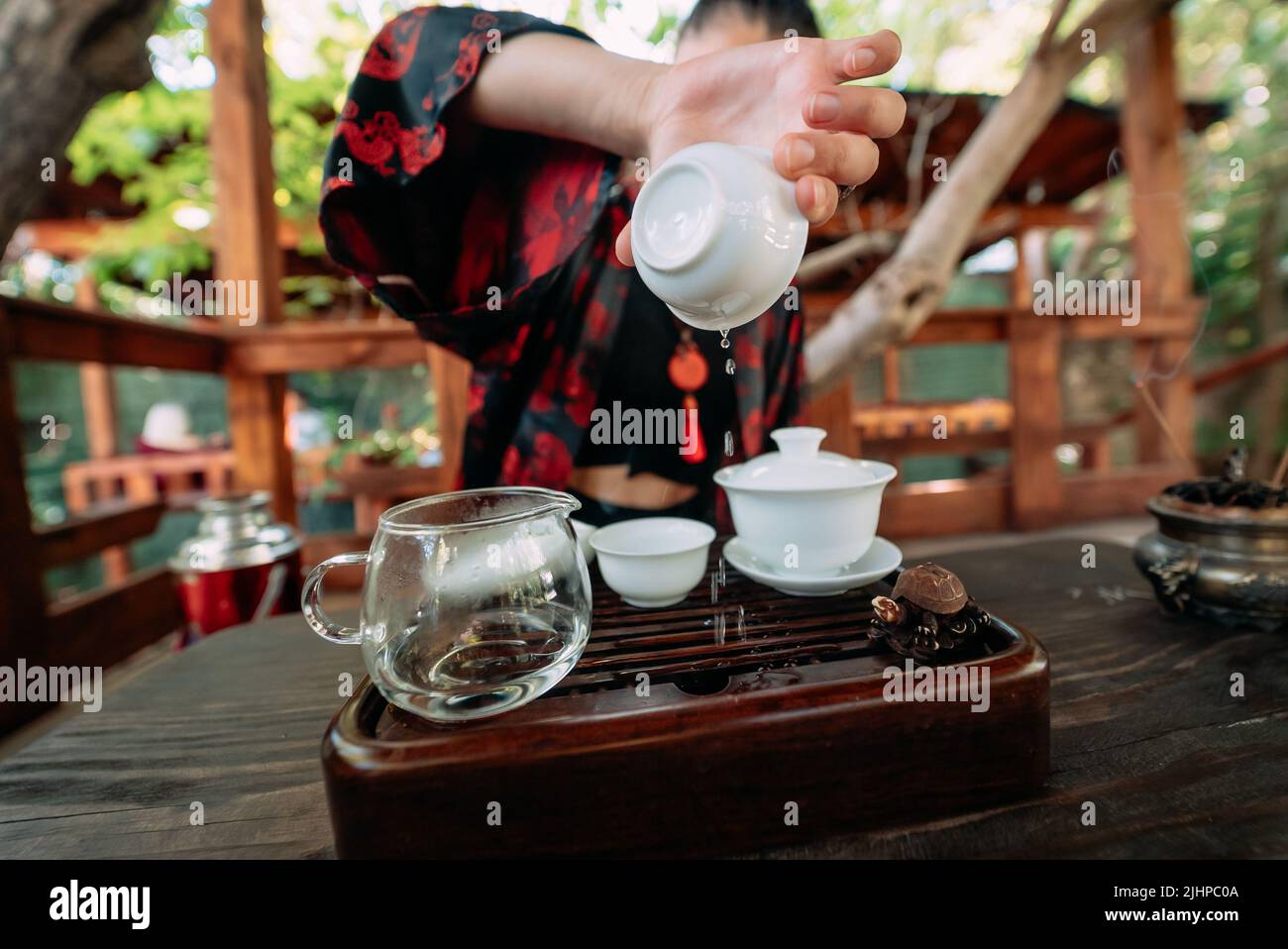 Young girl pouring water from cup closeup Stock Photo Alamy