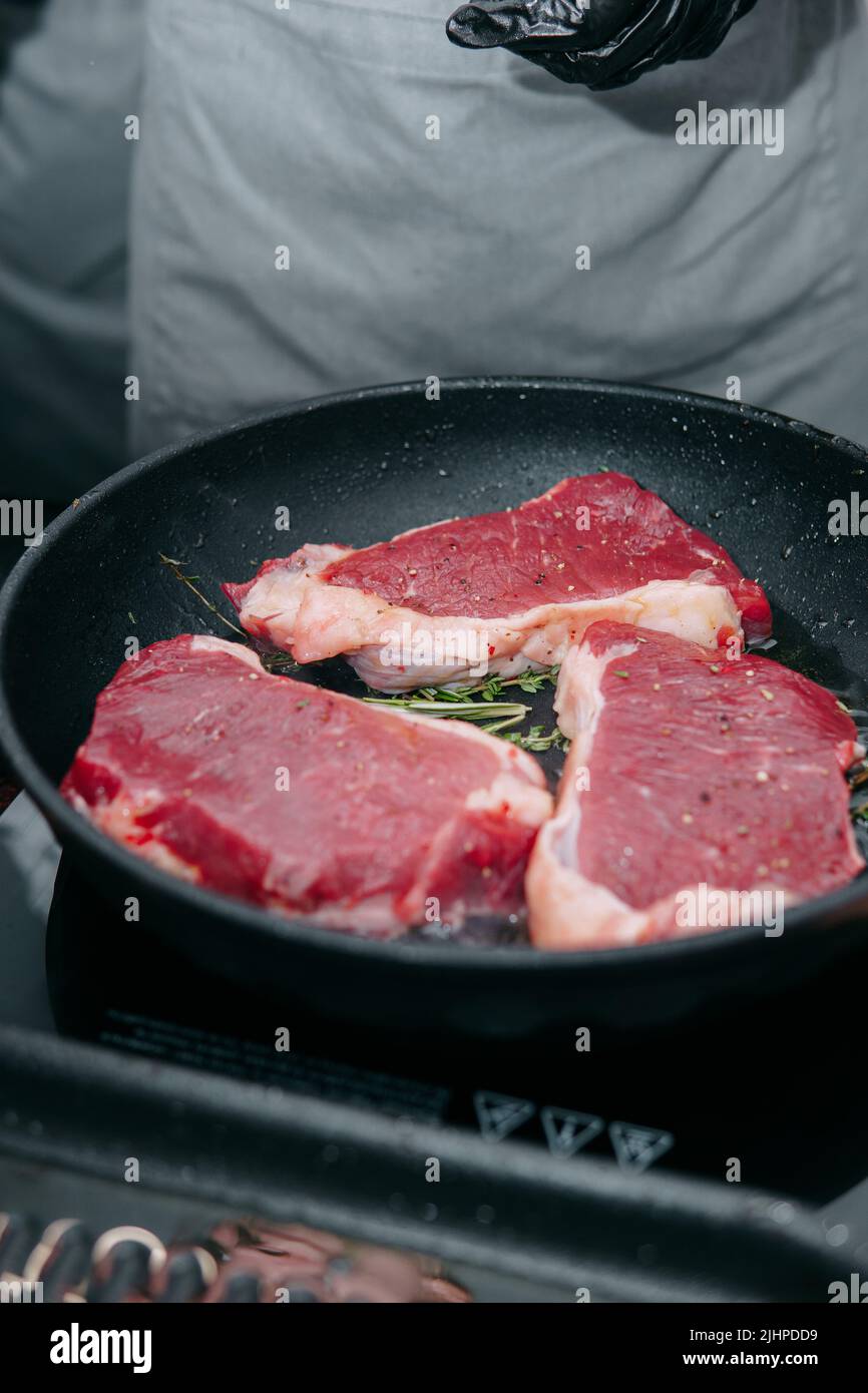 cooking steaks in a pan. cooking beef at the culinary master class. the
