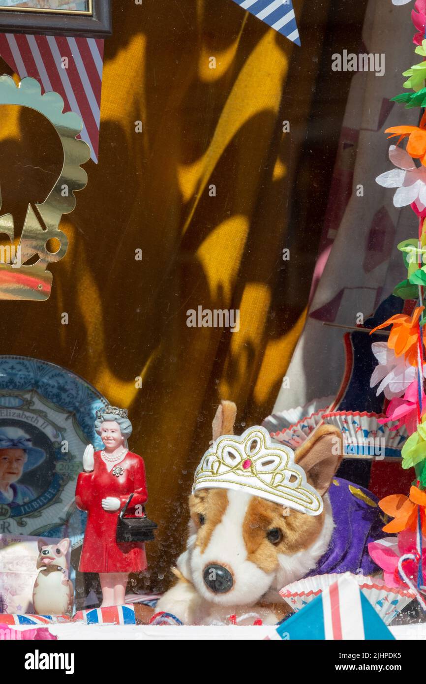 Unofficial decorations for the Platinum Jubilee of Queen Elizabeth II include a waving model queen and a soft toy corgi wearing a tiara. Stock Photo