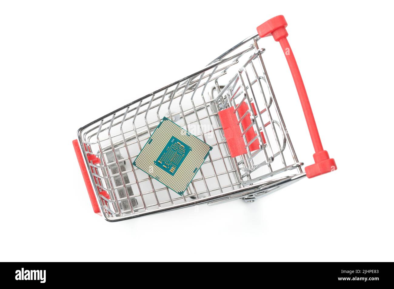 Toy shopping cart with computer part (CPU). Top view isolated on white Stock Photo