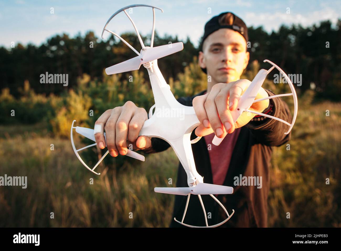 Young man holding drone with both hands Stock Photo