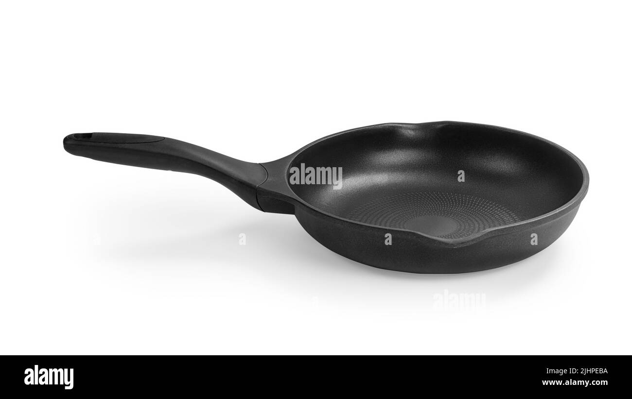 Black frying pan on the table side view. Isolated on white, clipping path included Stock Photo