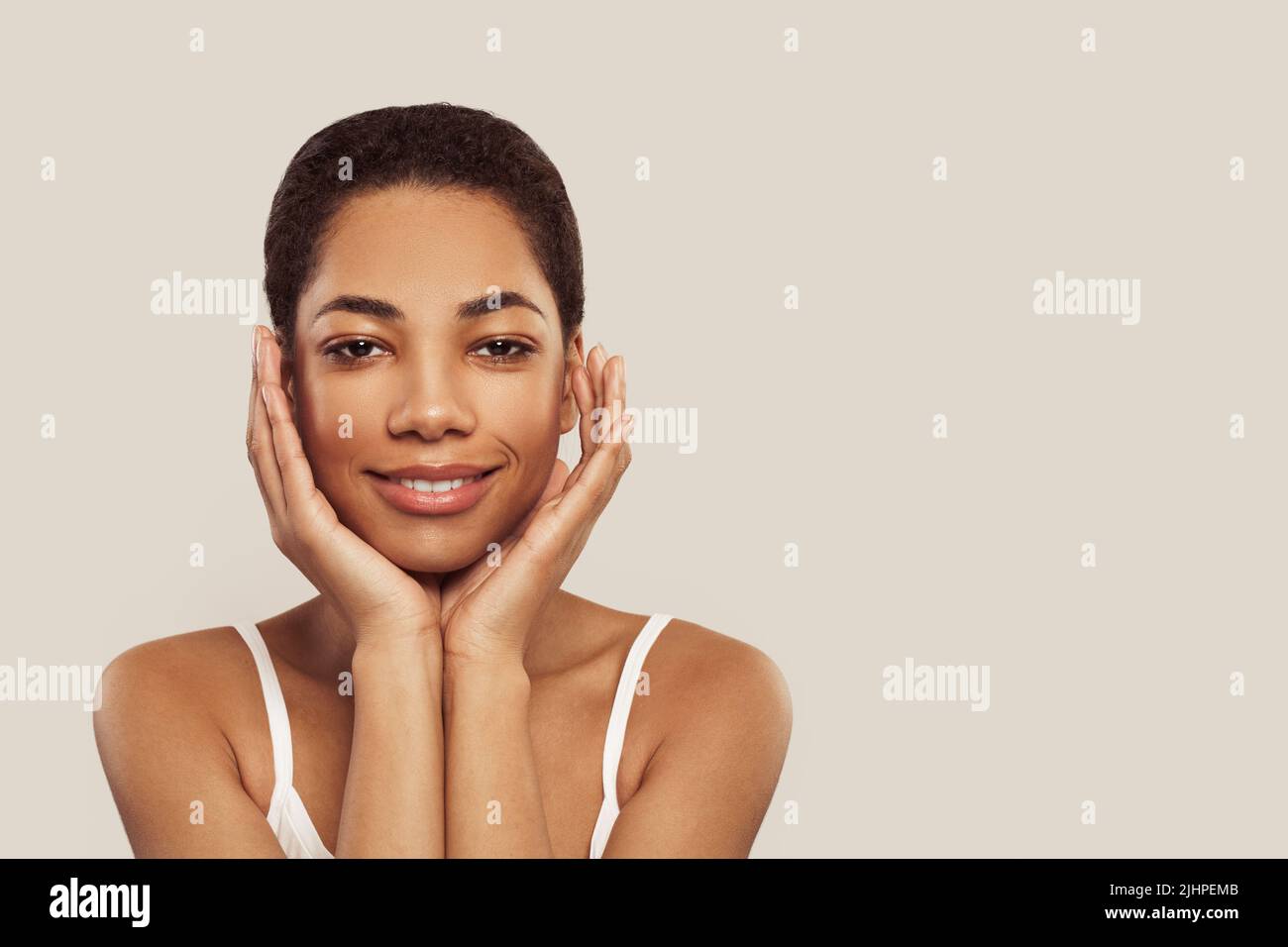 Happy african american woman touching soft smooth skin on her face on ...