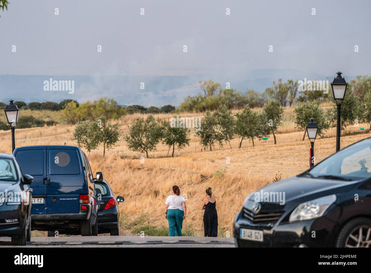 Madrid, Spain. 19th July, 2022. Two women look at the smoke from the Valdepeñas de la Sierra fire. The Valdepeñas de la Sierra fire in Guadalajara, Spain, devastates 2,300 hectares and leaves dozens of families homeless. The fires occurred in relation to the summer season and the high air temperatures and strong winds, however the authorities do not rule out that the fire could have been provoked. Credit: SOPA Images Limited/Alamy Live News Stock Photo