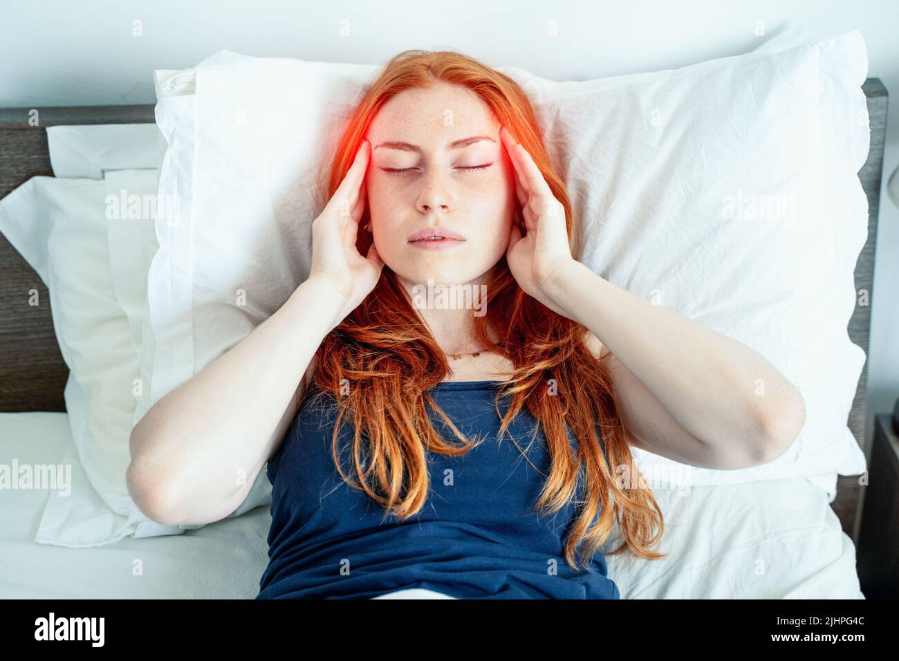 One woman suffering insomnia disturbed by head pain Stock Photo