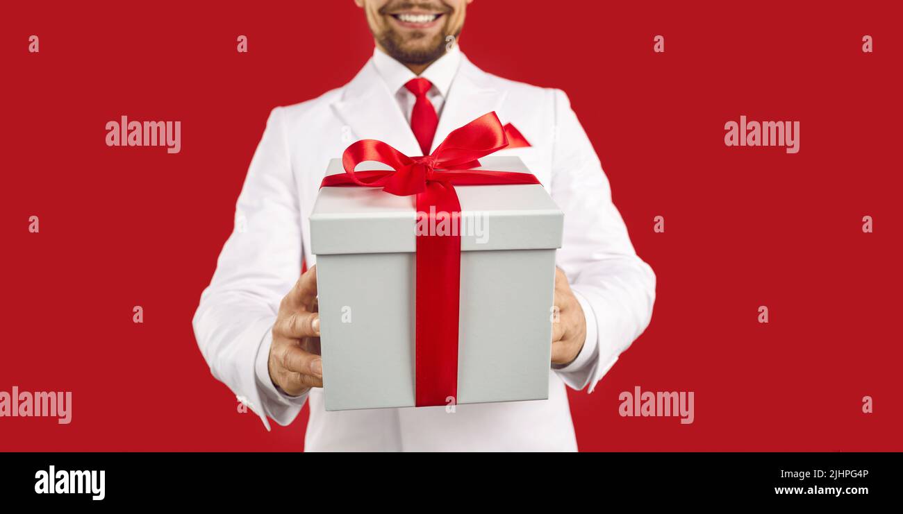 Banner of man in suit present wrapped gift box Stock Photo