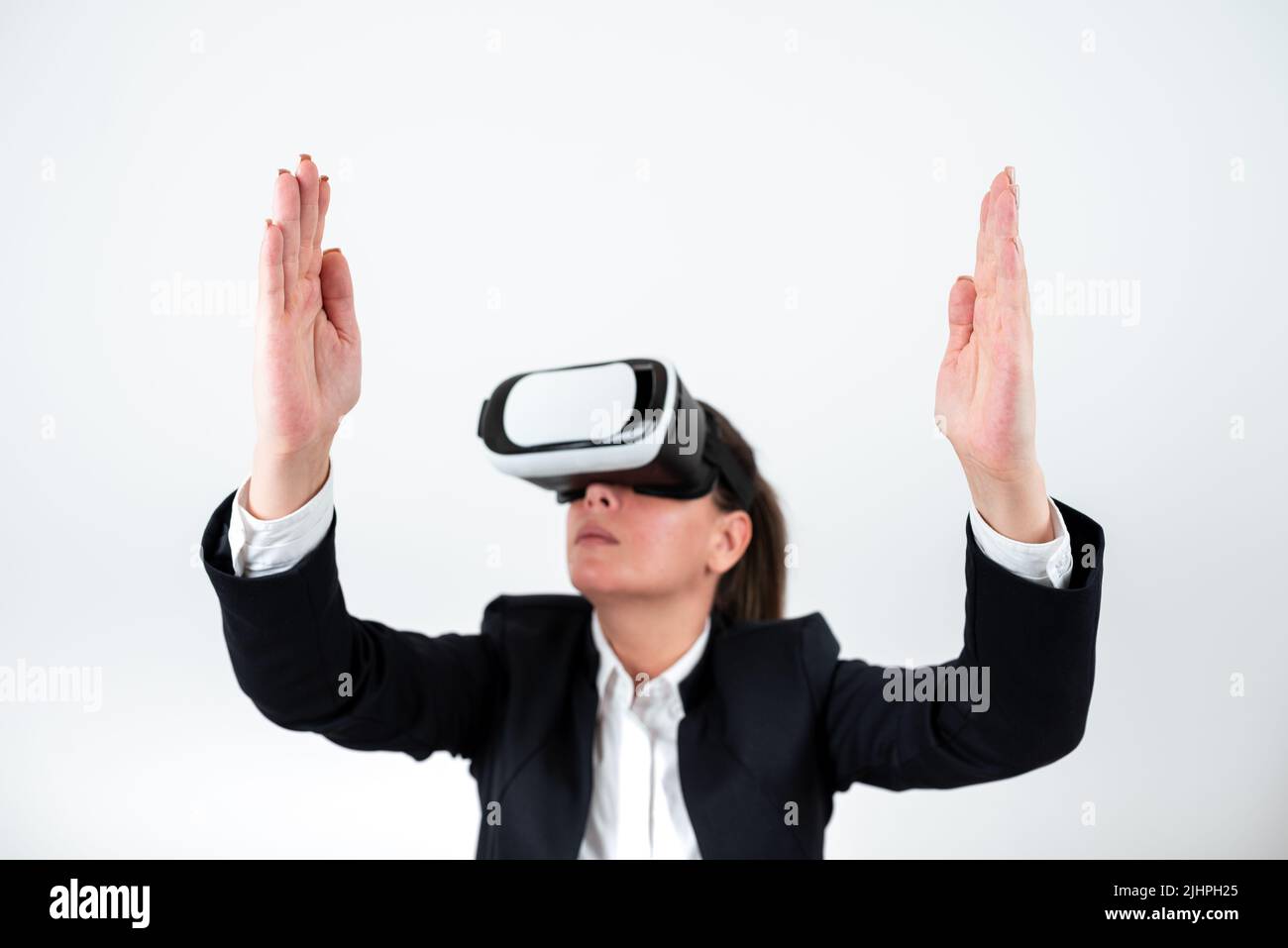 Woman Wearing Vr Glasses And Presenting Important Messages Between Hands. Businesswoman Having Virtual Reality Eyeglasses And Showing Crutial Stock Photo