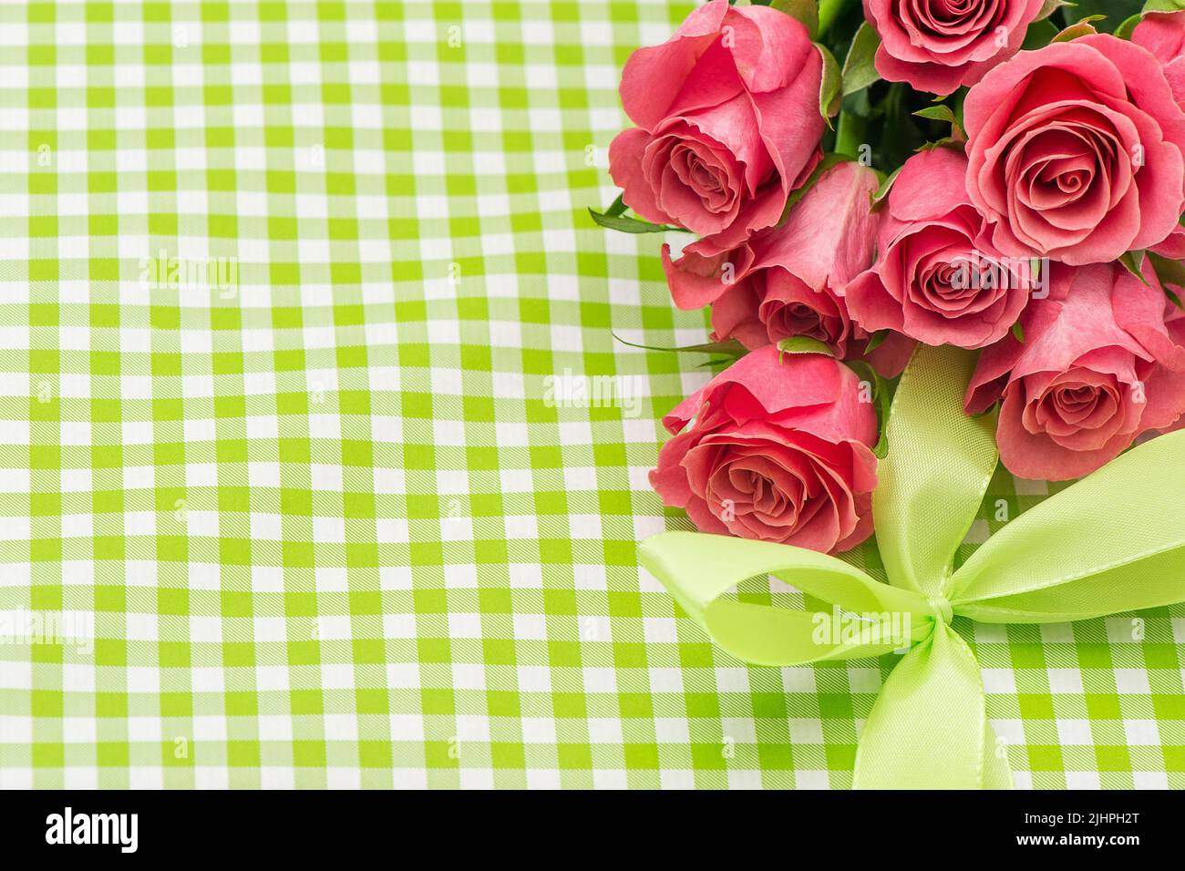 Pink roses flowers ribbon bow gift background. Floral festive arrangement Stock Photo